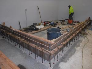 Installing # 4 rebar with epoxy in drill holes in hypochlorite tank room