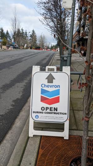 Signage at the project site indicating the adjacent Chevron gas station remains open to the public