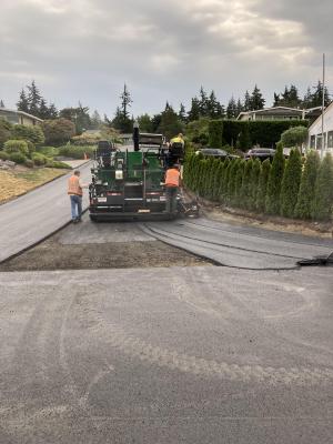 Watson’s asphalt paver placing the first lift of hot mix asphalt on SE 66th Street.