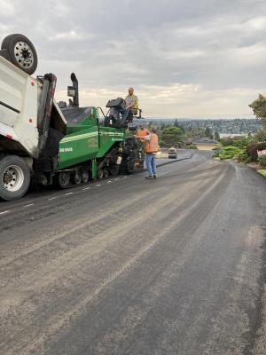  A super solo dump truck dumps asphalt into Watson’s asphalt paver while paving the first lift on SE 67th Street.