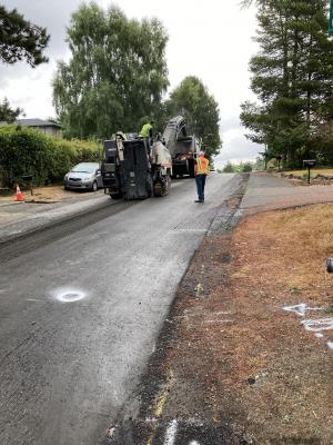 Milling machine removing existing asphalt to prepare for paving on SE 39th Street