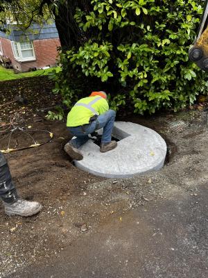 Adjusting existing storm drainage structure to new asphalt grade.