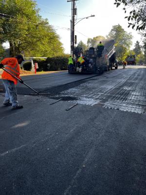 Paving top lift of asphalt on SE 36th Street and 88th Avenue SE.