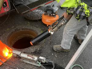 A sewer bypass plug is inserted into the upstream pipe. 