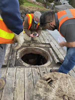 Consultants looking down into pump station