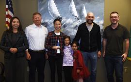 Photo of Community of the Year awardee Fan Yuan, her family, and members of the City Council