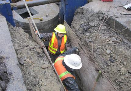 Crews work in trench 