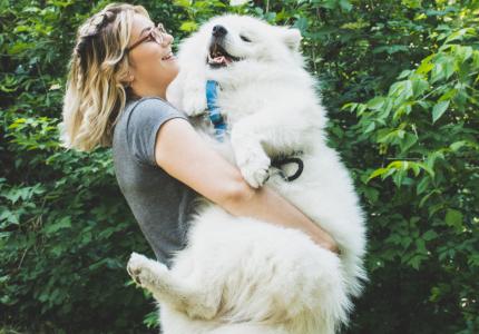 Woman holding pet dog