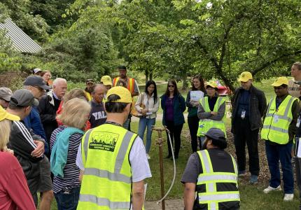 2024 Emergency Well Training - Staff and Volunteers gather around water distribution site