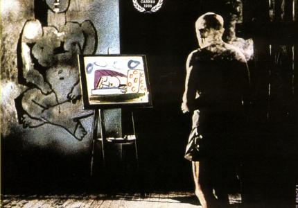 A movie poster featuring a black and white image of the artist Picasso painting Cubist figures