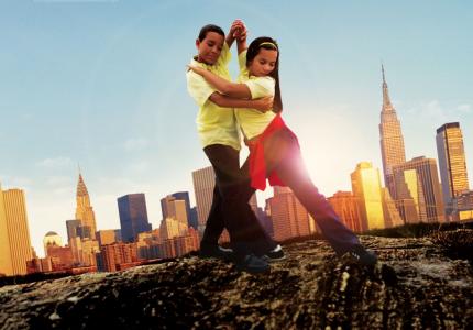 A movie poster featuring a boy and girl ballroom dancing against a blue sky and New York City skyline backdrop