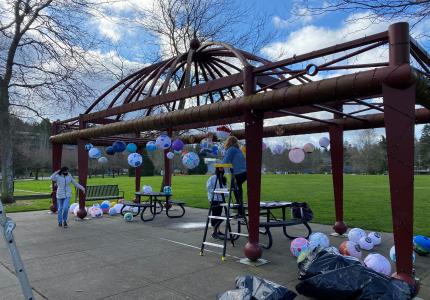 Community members install creative lanterns in Mercerdale Park as part of the 2021 Island Lanterns project.