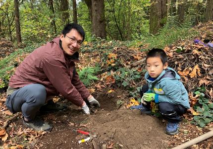 A father and sun planting a tree.