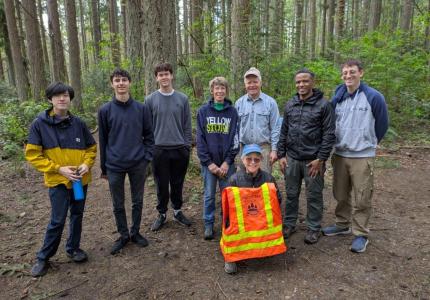 Volunteers posing in a forest
