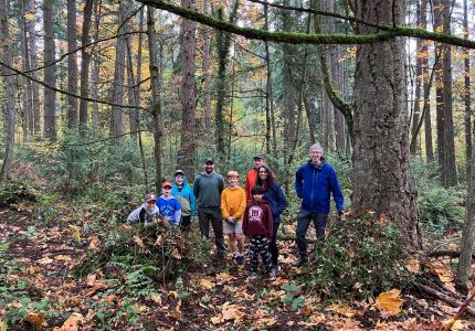 A group of volunteers posing in the woods.