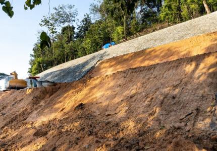 Heavy equipment clearing and grading hillside 