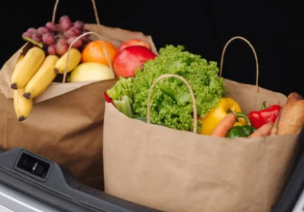Two bags of groceries in car trunk