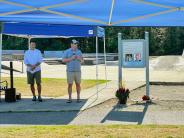Mayor Nice and Clay Robinson speaking at dedication event in front of skate park