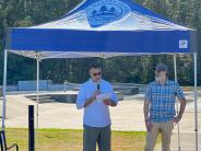 Mayor Nice and Josh Moreman speaking at dedication event in front of skate park