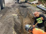 Crews replace a section of water main