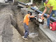Crews replace a section of water main