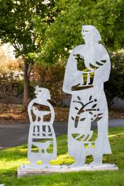 Two cutout steel figures stand at the gateway to Mercer Island, welcoming visitors to the Island.