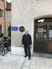 Mayor Benson Wong standing beside the plaque at Thonon les Bains City Hall commemorating the sister city relationship with Merce