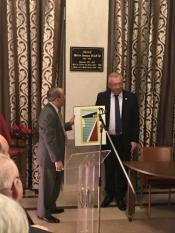 Mayor Benson Wong presenting a gift of art from the City of Mercer Island to Mayor Jean Denais.