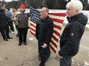 Mayor Benson Wong and Terry Mark standing in front of a 48-star US flag from WWII.