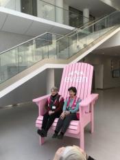 Jane Meyer Brahm and Terry Moreman try out the big Evian Adirondack in the lobby.