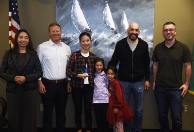 Photo of Community of the Year awardee Fan Yuan, her family, and members of the City Council