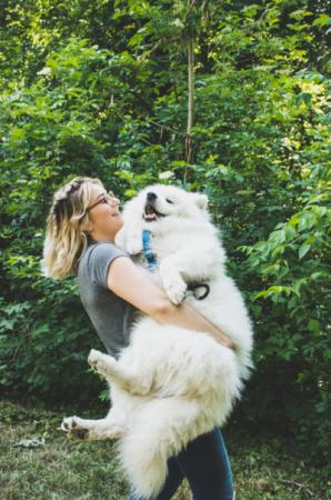 Woman holding pet dog