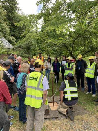 2024 Emergency Well Training - Staff and Volunteers gather around water distribution site
