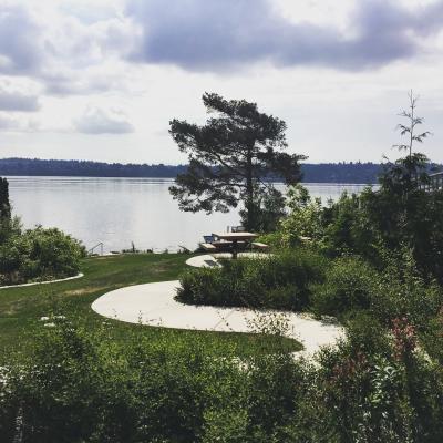 A street end park featuring a concrete path to a picnic table and stairs down to Lake Washingon