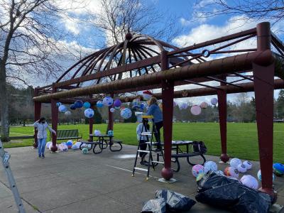 Community members install creative lanterns in Mercerdale Park as part of the 2021 Island Lanterns project.