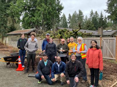 A group of smiling volunteers posing on a trail. 