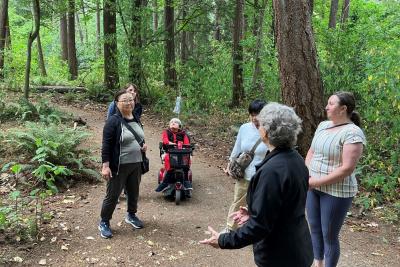 Participants looking up in a forest.
