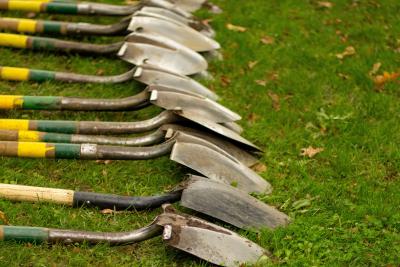 Shovels laid out on the grass 