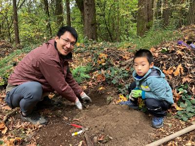 A father and sun planting a tree.