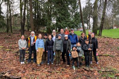 Group of volunteers posing in front of a forest