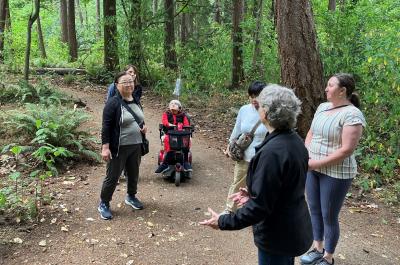 A group of participants looking up in the forest.