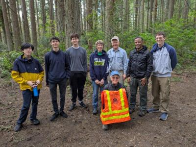 Volunteers posing in a forest