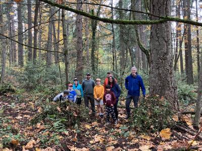 A group of volunteers posing in the woods.