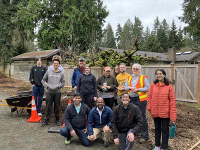 A group of volunteers posing on the side of the trail