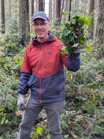 Person holding a clump of ivy. 