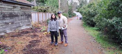 Two volunteers posing happily alongside the trail.