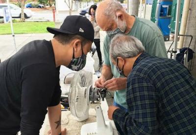 Photo courtesy of King County Solid Waste Division. Fixers work on an item at a King County Repair event.