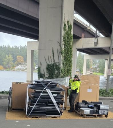 Event staff securing a pallet of electronics in plastic wrap for recycling