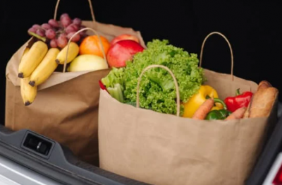 Two bags of groceries in car trunk