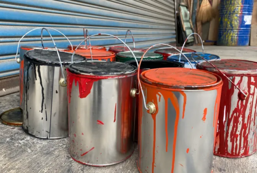 Image with multiple different colors of paint gallons.